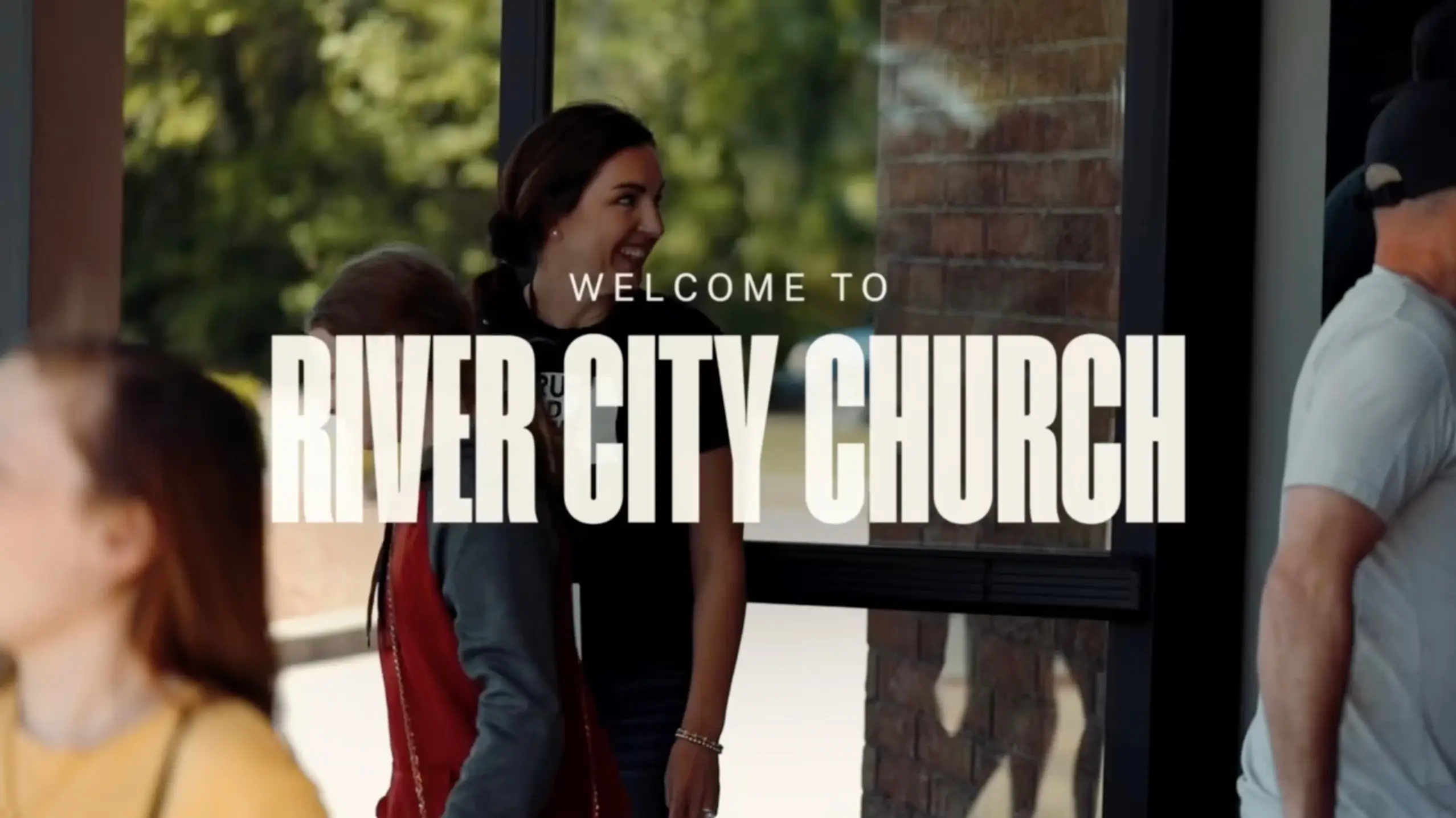 Welcome to River City Church — congregants greeting each other on a Sunday morning.